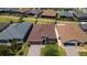 An aerial view shows this home's appealing landscaping, two car garage, and neighborhood setting in a residential community at 125 Silver Maple Rd, Groveland, FL 34736