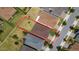 This aerial view shows a large private lot, a meticulously maintained lawn, and a well-maintained single-Gathering home at 125 Silver Maple Rd, Groveland, FL 34736