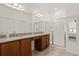 Bright bathroom with double sink vanity, granite counters, and glass enclosed shower at 125 Silver Maple Rd, Groveland, FL 34736
