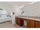 Bathroom featuring double vanity, granite countertops and tile flooring, adjacent to the main bedroom at 125 Silver Maple Rd, Groveland, FL 34736