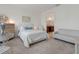 Inviting bedroom with neutral tones, leading to ensuite bathroom, and cozy seating area at 125 Silver Maple Rd, Groveland, FL 34736