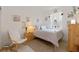 A cozy bedroom decorated with soft colors and textures featuring a large window and chair at 125 Silver Maple Rd, Groveland, FL 34736
