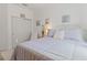 Comfortable bedroom featuring a bed with patterned bedding, a window and white trim at 125 Silver Maple Rd, Groveland, FL 34736