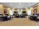 Well-lit card room with multiple tables, chairs, and wall-mounted TVs at 125 Silver Maple Rd, Groveland, FL 34736