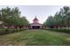 Beautifully landscaped clubhouse with manicured lawn and mature shade trees at 125 Silver Maple Rd, Groveland, FL 34736
