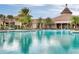 Large community pool with ample seating and clubhouse in the background at 125 Silver Maple Rd, Groveland, FL 34736