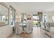 Bright dining room with modern decor, view to backyard through the sliding glass doors at 125 Silver Maple Rd, Groveland, FL 34736