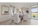 Bright dining room with large windows, modern decor, and tile floors at 125 Silver Maple Rd, Groveland, FL 34736