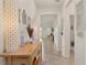Inviting hallway features neutral walls, tiled floor, and tasteful decor, creating a warm and welcoming ambiance at 125 Silver Maple Rd, Groveland, FL 34736