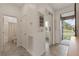 Bright hallway featuring an open doorway to the exterior and sliding door to another room at 125 Silver Maple Rd, Groveland, FL 34736