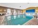 Bright indoor pool area with lounge chairs and large windows at 125 Silver Maple Rd, Groveland, FL 34736