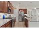 Kitchen featuring stainless appliances, granite counters and a pass-through to the adjacent living space at 125 Silver Maple Rd, Groveland, FL 34736