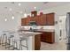 Beautiful kitchen with granite countertops, wood cabinets, a spacious island, and modern stainless steel appliances at 125 Silver Maple Rd, Groveland, FL 34736
