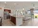 Modern kitchen with stainless steel appliances, granite countertops and breakfast bar seating open to the dining and living areas at 125 Silver Maple Rd, Groveland, FL 34736