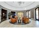 Elegant lobby with leather chairs, designer rug, and view to dining area at 125 Silver Maple Rd, Groveland, FL 34736