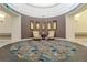 Inviting lobby area with armchairs, accent wall, and decorative rug at 125 Silver Maple Rd, Groveland, FL 34736