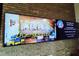 Large media screen displaying local events in the community grille at 125 Silver Maple Rd, Groveland, FL 34736