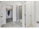 Bathroom featuring tiled shower, walk-in closet, and neutral color palette at 1251 Blue Daze Ln, Eustis, FL 32726