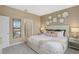 Cozy bedroom featuring a neutral color scheme, comfortable bed, and a mirrored closet door at 1251 Blue Daze Ln, Eustis, FL 32726