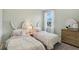 Charming bedroom with twin beds, bunny ear headboards, and a bright window at 1251 Blue Daze Ln, Eustis, FL 32726