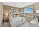Bright bedroom with stylish accent wall, plush bedding, and a large window with a view at 1251 Blue Daze Ln, Eustis, FL 32726