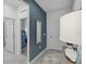 Stylish hallway featuring a blue accent wall with mirror, leading to various rooms at 1251 Blue Daze Ln, Eustis, FL 32726