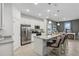 Modern kitchen with stainless steel appliances, granite countertops, and a breakfast bar at 1251 Blue Daze Ln, Eustis, FL 32726