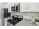Close-up of the kitchen appliances, featuring a stainless steel microwave and oven at 1251 Blue Daze Ln, Eustis, FL 32726