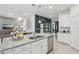 Modern kitchen showcasing granite countertops, stainless steel appliances, and an island with a double sink at 1251 Blue Daze Ln, Eustis, FL 32726