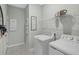 Functional laundry room with a washing machine, dryer, shelving, and neutral wall color at 1251 Blue Daze Ln, Eustis, FL 32726