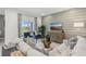 Bright living room with large sliding glass doors, plush sofas, and modern furnishings at 1251 Blue Daze Ln, Eustis, FL 32726