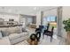 Open-concept living room flowing into the dining area, featuring stylish decor and natural light at 1251 Blue Daze Ln, Eustis, FL 32726