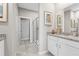 Bathroom with double sinks, granite countertops, tiled floor and walk-in shower at 1252 Blue Daze Ln, Eustis, FL 32726