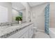 Bright bathroom with double sinks, granite countertops and tub with shower at 1252 Blue Daze Ln, Eustis, FL 32726
