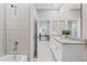 Bathroom featuring double vanity with granite countertops and shower over tub at 1252 Blue Daze Ln, Eustis, FL 32726