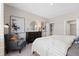 Bedroom featuring a comfortable chair, dresser, modern art and natural light at 1252 Blue Daze Ln, Eustis, FL 32726