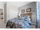 Comfortable bedroom featuring a large bed with stylish blue patterned bedding and a woven headboard at 1252 Blue Daze Ln, Eustis, FL 32726