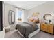 Well-lit bedroom showcases a comfy bed, full-length mirror and decorative accents at 1252 Blue Daze Ln, Eustis, FL 32726
