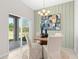Dining area with modern chandelier, stylish artwork, and sliding glass doors to the backyard at 1252 Blue Daze Ln, Eustis, FL 32726