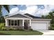 Charming single-Gathering home featuring stone accents, a two-car garage, and a well-manicured lawn at 1252 Blue Daze Ln, Eustis, FL 32726