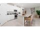 Modern kitchen with white cabinetry, granite countertops, a kitchen island, and stainless steel appliances at 1252 Blue Daze Ln, Eustis, FL 32726