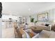 Spacious living room featuring an open layout with a view of the modern kitchen and dining area at 1252 Blue Daze Ln, Eustis, FL 32726