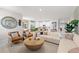 Beautifully decorated living room with stylish seating, modern decor, and an open view into the kitchen area at 1252 Blue Daze Ln, Eustis, FL 32726