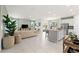 Bright, open-concept living space with tile flooring, a spacious seating area, and a modern kitchen island at 1252 Blue Daze Ln, Eustis, FL 32726