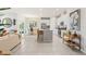 Open-concept living space with a modern kitchen, dining area, and cozy living room, perfect for entertaining at 1252 Blue Daze Ln, Eustis, FL 32726