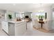Open-concept layout featuring a modern kitchen with granite countertops, a dining area, and a comfortable living space at 1252 Blue Daze Ln, Eustis, FL 32726
