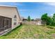 Fenced backyard features a well-maintained lawn and mature trees, creating a private outdoor space at 128 Brushcreek Dr, Sanford, FL 32771