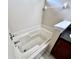 Close up view of a bright bathtub in a bathroom with tiled walls and a shower head at 128 Brushcreek Dr, Sanford, FL 32771