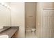 A full bathroom features a granite sink, tile floor, a toilet, and a storage closet at 128 Brushcreek Dr, Sanford, FL 32771