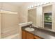 Bathroom featuring a large mirror, a granite sink, and a window, providing a functional and bright space at 128 Brushcreek Dr, Sanford, FL 32771